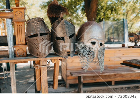 Exhibition of Medieval knightly armor in ancient fortress. Swords, shields and other weapons. Exhibition of Medieval knightly armor in ancient fortress. Swords, shields and other weapons. 72008342