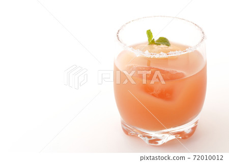 Photographed a pink salty dog with mint with salt on the edge of the glass on a white background Photographed a pink salty dog with mint with salt on the edge of the glass on a white background 72010012