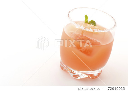 Photographed a pink salty dog with mint with salt on the edge of the glass on a white background Photographed a pink salty dog with mint with salt on the edge of the glass on a white background 72010013