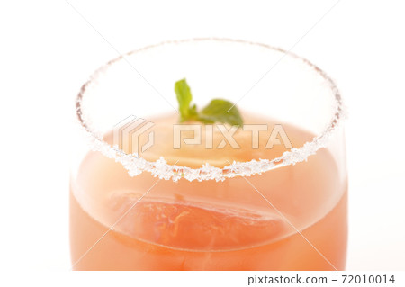 Photographed a pink salty dog with mint with salt on the edge of the glass on a white background Photographed a pink salty dog with mint with salt on the edge of the glass on a white background 72010014