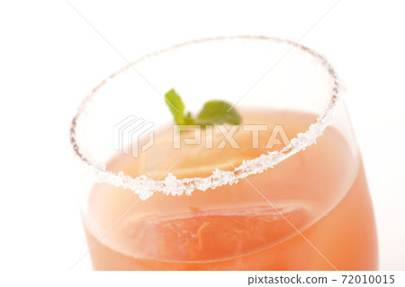 Photographed a pink salty dog with mint with salt on the edge of the glass on a white background Photographed a pink salty dog with mint with salt on the edge of the glass on a white background 72010015