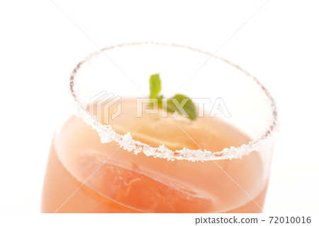 Photographed a pink salty dog with mint with salt on the edge of the glass on a white background 72010016