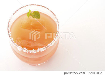 Photographed a pink salty dog with mint with salt on the edge of the glass on a white background Photographed a pink salty dog with mint with salt on the edge of the glass on a white background 72010034