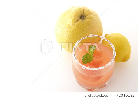 Photographed pink salty dog with mint with salt on the edge of the glass, grapefruit and lemon on a white background Photographed pink salty dog with mint with salt on the edge of the glass, grapefruit and lemon on a white background 72010182