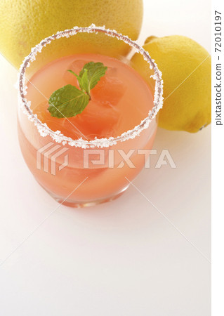 Photographed pink salty dog with mint with salt on the edge of the glass, grapefruit and lemon on a white background Photographed pink salty dog with mint with salt on the edge of the glass, grapefruit and lemon on a white background 72010197