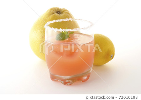 Photographed pink salty dog with mint with salt on the edge of the glass, grapefruit and lemon on a white background Photographed pink salty dog with mint with salt on the edge of the glass, grapefruit and lemon on a white background 72010198