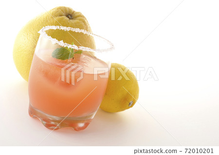 Photographed pink salty dog with mint with salt on the edge of the glass, grapefruit and lemon on a white background 72010201