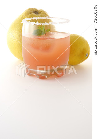 Photographed pink salty dog with mint with salt on the edge of the glass, grapefruit and lemon on a white background Photographed pink salty dog with mint with salt on the edge of the glass, grapefruit and lemon on a white background 72010206