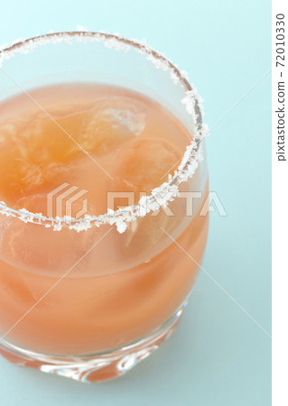 Pink salty dog with salt on the edge of the glass Pink salty dog with salt on the edge of the glass 72010330