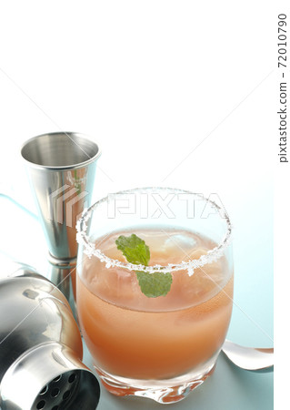 Salty dog with mint with salt on the edge of the glass, cocktail shaker and major cup Salty dog with mint with salt on the edge of the glass, cocktail shaker and major cup 72010790