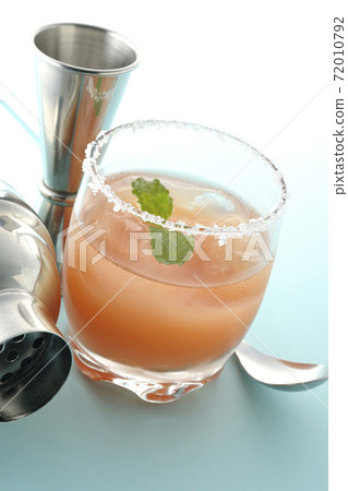 Salty dog with mint with salt on the edge of the glass, cocktail shaker and major cup Salty dog with mint with salt on the edge of the glass, cocktail shaker and major cup 72010792