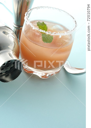 Salty dog with mint with salt on the edge of the glass, cocktail shaker and major cup Salty dog with mint with salt on the edge of the glass, cocktail shaker and major cup 72010794