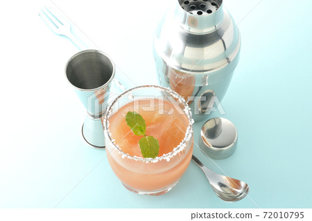 Salty dog with mint with salt on the edge of the glass, cocktail shaker and major cup Salty dog with mint with salt on the edge of the glass, cocktail shaker and major cup 72010795