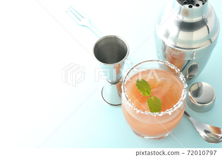 Salty dog with mint with salt on the edge of the glass, cocktail shaker and major cup Salty dog with mint with salt on the edge of the glass, cocktail shaker and major cup 72010797