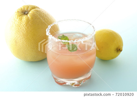 Pink salty dog with mint and grapefruit and lemon with salt on the edge of the glass Pink salty dog with mint and grapefruit and lemon with salt on the edge of the glass 72010920