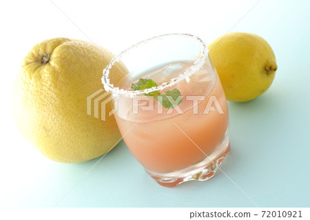 Pink salty dog with mint and grapefruit and lemon with salt on the edge of the glass Pink salty dog with mint and grapefruit and lemon with salt on the edge of the glass 72010921