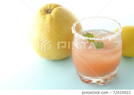 Pink salty dog with mint and grapefruit and lemon with salt on the edge of the glass Pink salty dog with mint and grapefruit and lemon with salt on the edge of the glass 72010922