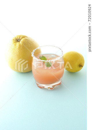 Pink salty dog with mint and grapefruit and lemon with salt on the edge of the glass Pink salty dog with mint and grapefruit and lemon with salt on the edge of the glass 72010924
