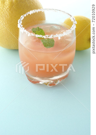 Pink salty dog with mint and grapefruit and lemon with salt on the edge of the glass Pink salty dog with mint and grapefruit and lemon with salt on the edge of the glass 72010929