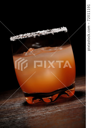 Pink salty dog with salt on the edge of the glass Pink salty dog with salt on the edge of the glass 72011191