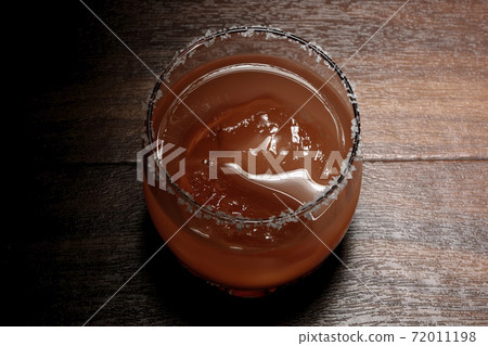 Pink salty dog with salt on the edge of the glass Pink salty dog with salt on the edge of the glass 72011198