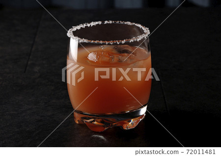 Pink salty dog with salt on the edge of the glass 72011481