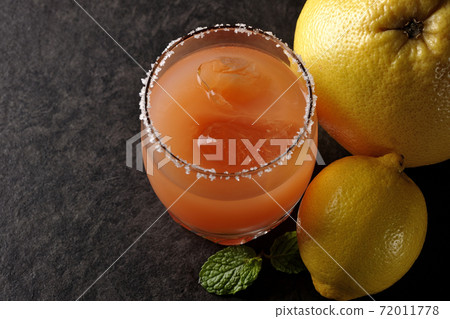 Salty dog with salt on the edge of the glass, grapefruit, lemon and mint Salty dog with salt on the edge of the glass, grapefruit, lemon and mint 72011778