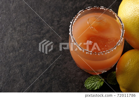 Salty dog with salt on the edge of the glass, grapefruit, lemon and mint Salty dog with salt on the edge of the glass, grapefruit, lemon and mint 72011786