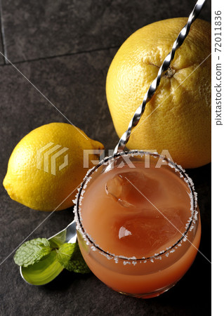Salty dog with salt on the edge of the glass, grapefruit, lemon, mint and bar spoon Salty dog with salt on the edge of the glass, grapefruit, lemon, mint and bar spoon 72011836