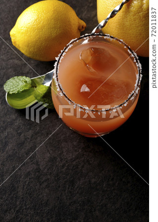Salty dog with salt on the edge of the glass, grapefruit, lemon, mint and bar spoon Salty dog with salt on the edge of the glass, grapefruit, lemon, mint and bar spoon 72011837