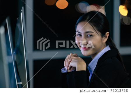 Portrait business young woman working overtime late at night in call center office. Portrait business young woman working overtime late at night in call center office. 72013758