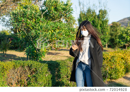 Mask smartphone park walk woman Mask smartphone park walk woman 72014928
