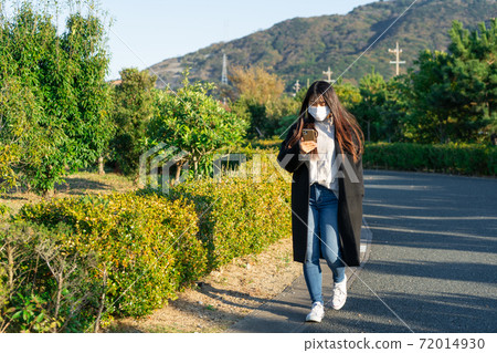Mask smartphone park walk woman Mask smartphone park walk woman 72014930