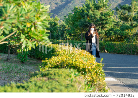 Mask smartphone park walk woman Mask smartphone park walk woman 72014932