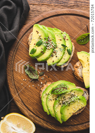 Healthy vegan avocado toast with hemp seeds 72015784