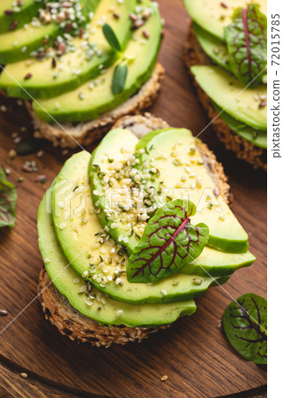 Avocado toasts with hemp seeds 72015785