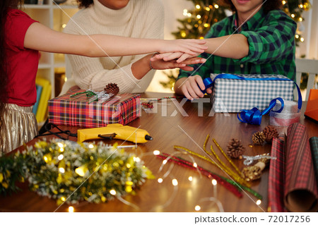 Teenage friends stacking hands 72017256