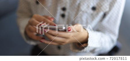 Close up view of female hands texting on smartphone Close up view of female hands texting on smartphone 72017811