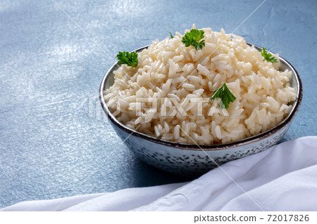 A bowl of white rice on a blue background 72017826