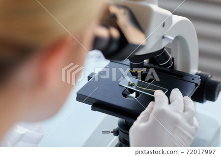 Woman Looking in Microscope Close Up Woman Looking in Microscope Close Up 72017997