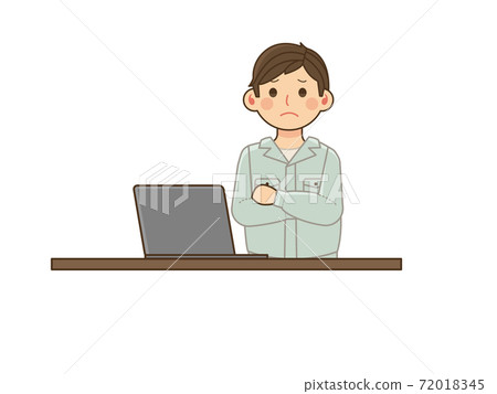 A man in work clothes who is worried with his arms crossed in front of a computer A man in work clothes who is worried with his arms crossed in front of a computer 72018345