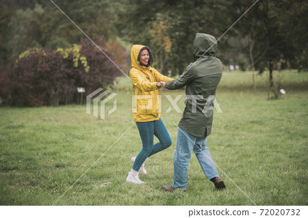 Young happy couple dancing in the park Young happy couple dancing in the park 72020732