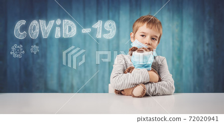Little boy sitting with a teddy bear in medical facial masks Little boy sitting with a teddy bear in medical facial masks 72020941