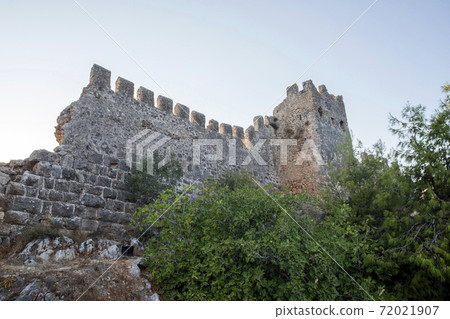 Elements of an ancient fortress. ancient city. Fortress on the rocks. Ruined walls of a medieval castle on the mountain. 72021907