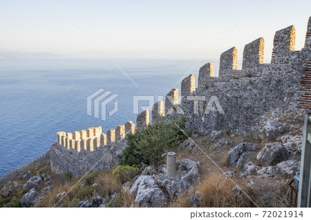 Elements of an ancient fortress. ancient city. Fortress on the rocks. Ruined walls of a medieval castle on the mountain. 72021914
