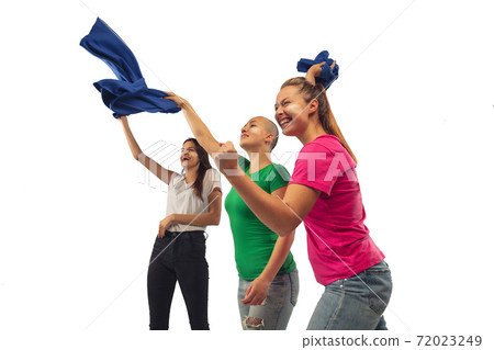 Female soccer fans cheering for favourite sport team with bright emotions isolated on white studio background Female soccer fans cheering for favourite sport team with bright emotions isolated on white studio background 72023249
