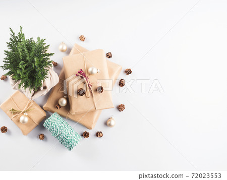 Xmas wrapped gifts stack and tree plant as gift 72023553