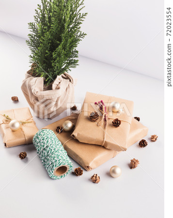 Xmas wrapped gifts stack and tree plant as gift Xmas wrapped gifts stack and tree plant as gift 72023554