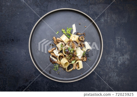 Traditional Italien calamarata noodles with mushroom and parmesan  72023925