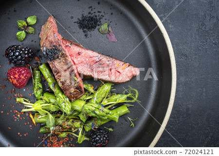 Modern design barbecue dry aged wagyu flank steak sliced with green asparagus Modern design barbecue dry aged wagyu flank steak sliced with green asparagus 72024121